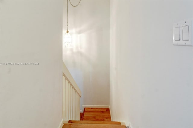 stairway with hardwood / wood-style floors