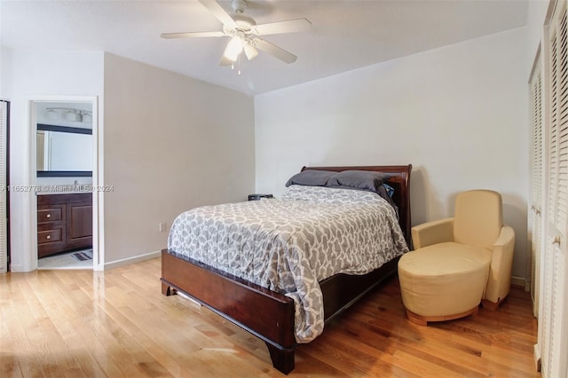 bedroom featuring hardwood / wood-style floors, ceiling fan, and ensuite bath