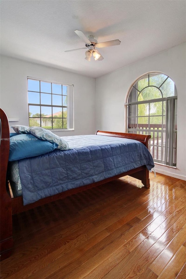 bedroom with wood-type flooring and ceiling fan