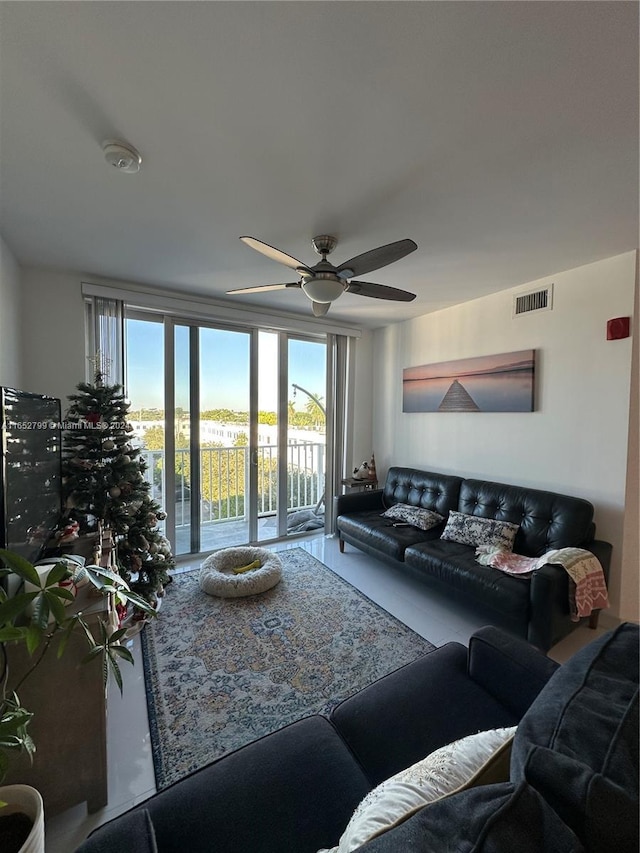 living room with a wealth of natural light and ceiling fan