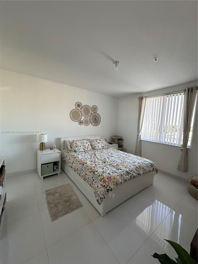 bedroom with light tile patterned floors