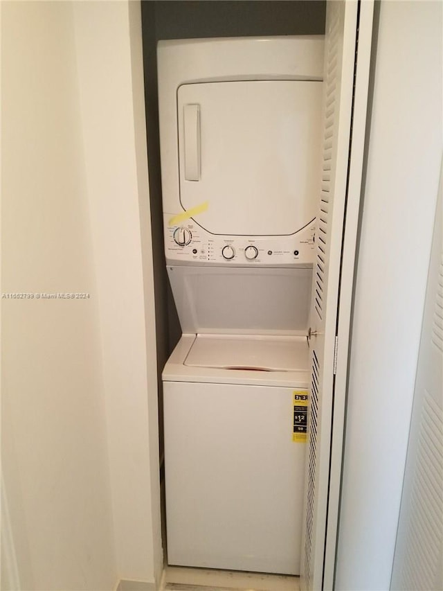 clothes washing area featuring stacked washer and dryer