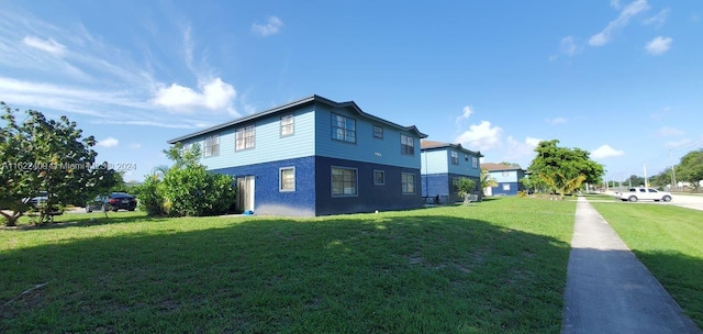 rear view of house featuring a lawn