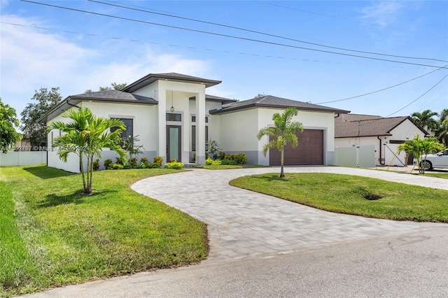 view of front of property with a garage and a front yard