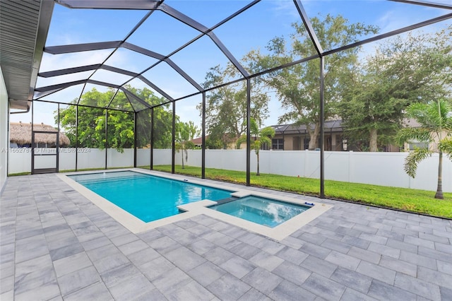 view of pool featuring a lanai, an in ground hot tub, and a patio