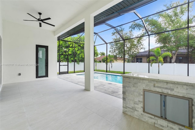 view of swimming pool with ceiling fan and a fireplace