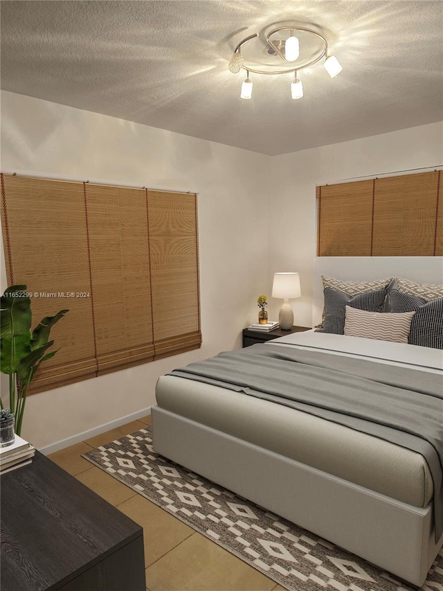 bedroom featuring a textured ceiling and light tile patterned flooring