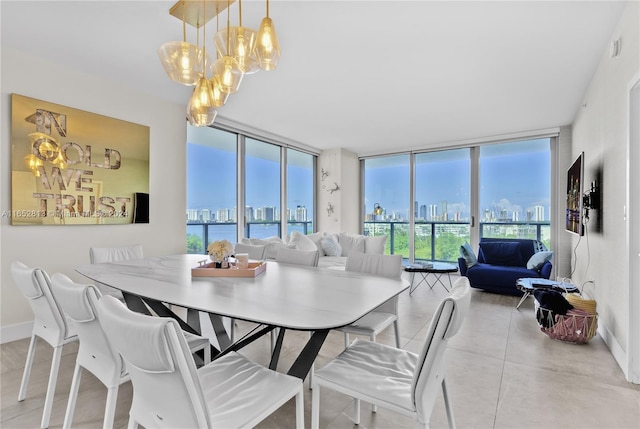 dining area with a chandelier and expansive windows