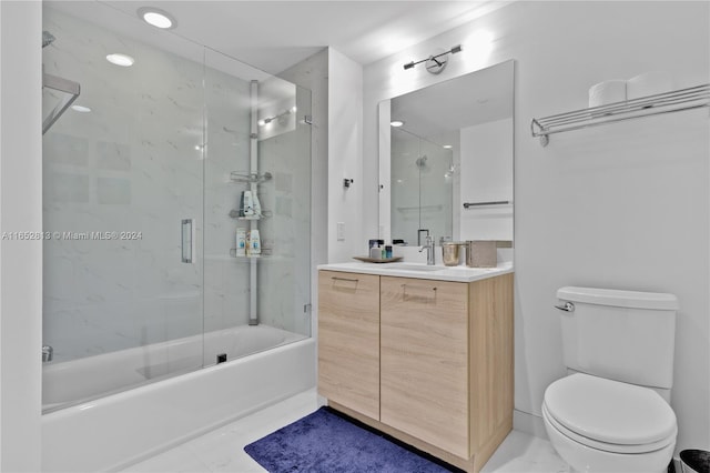 full bathroom with vanity, toilet, and combined bath / shower with glass door