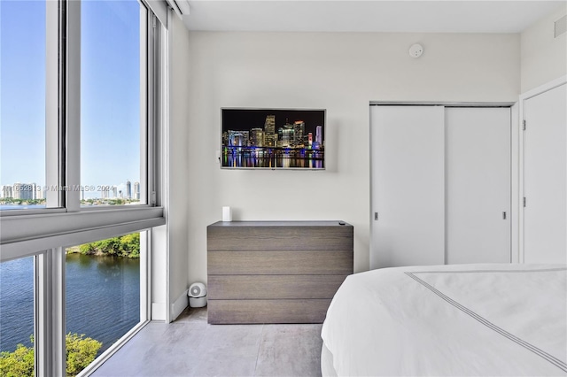 bedroom featuring a closet and a water view