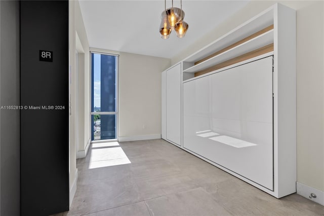 interior space featuring expansive windows and concrete floors