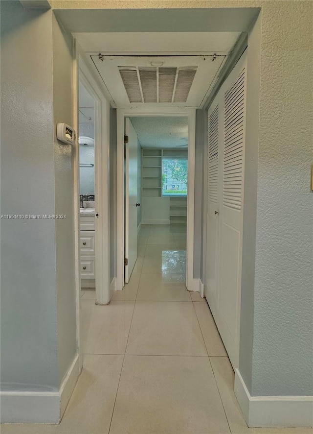 hallway with light tile patterned floors