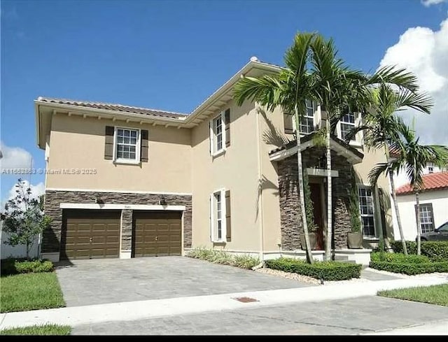 mediterranean / spanish-style house with a garage