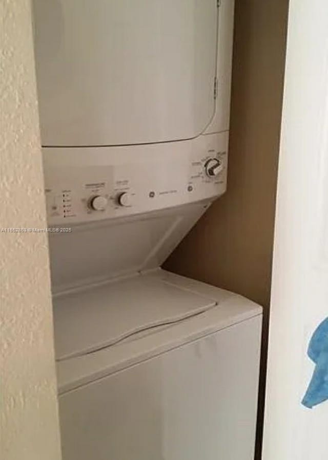 laundry area featuring stacked washer and dryer