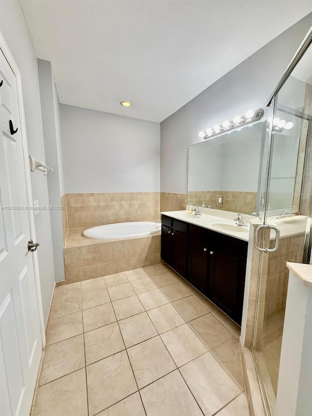 bathroom featuring independent shower and bath, tile patterned flooring, and vanity