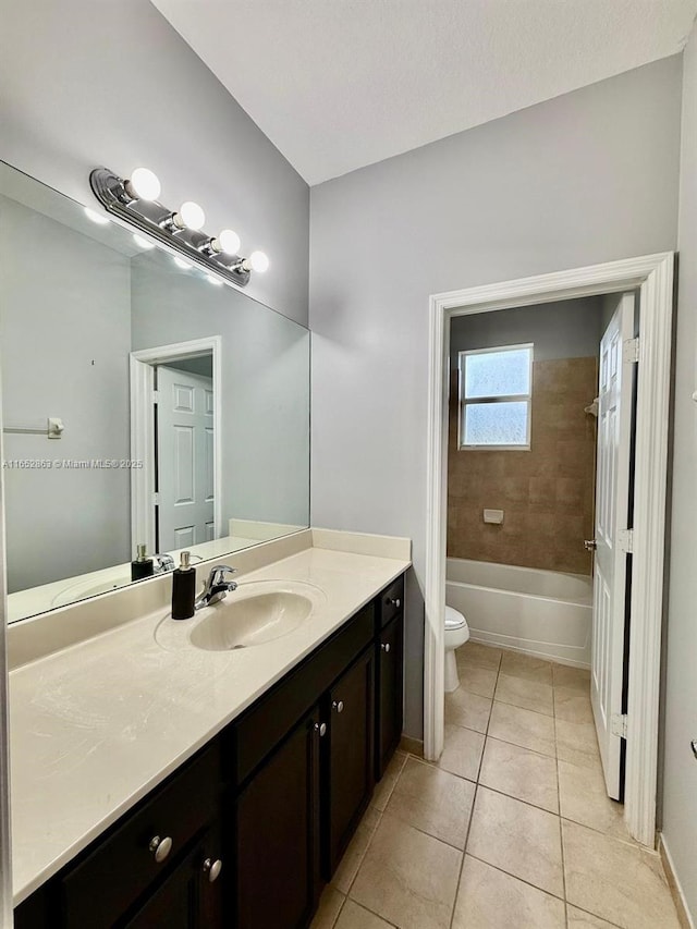 full bathroom with toilet, vanity, tiled shower / bath, and tile patterned flooring