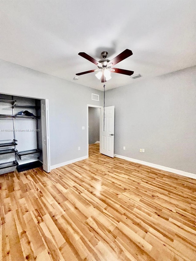 unfurnished bedroom with ceiling fan and light wood-type flooring