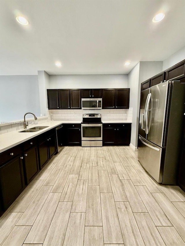 kitchen with sink, decorative backsplash, dark brown cabinetry, and stainless steel appliances