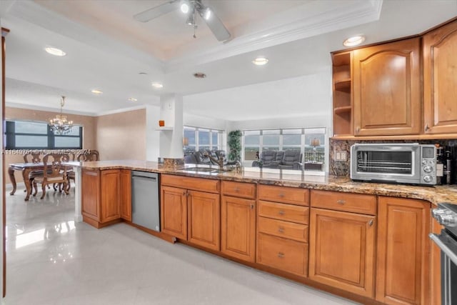 kitchen with ceiling fan with notable chandelier, light stone countertops, stainless steel appliances, ornamental molding, and kitchen peninsula