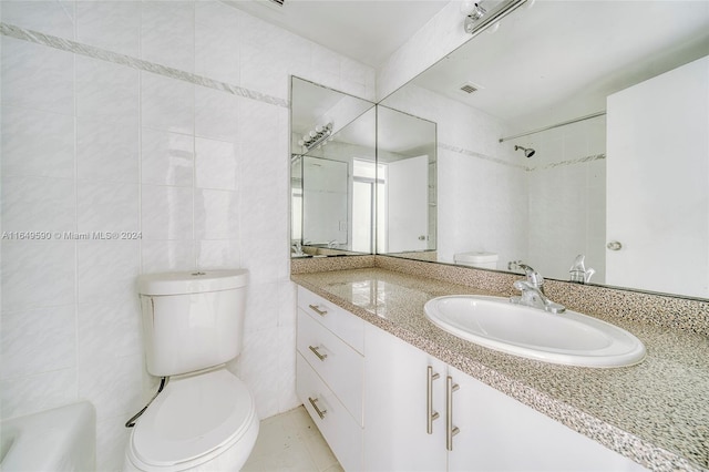 full bathroom featuring tile walls, vanity, tile patterned flooring, toilet, and bathtub / shower combination