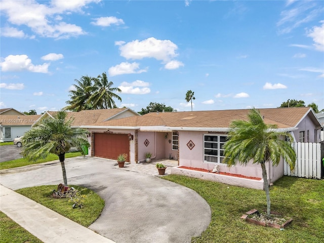 single story home featuring a front yard and a garage