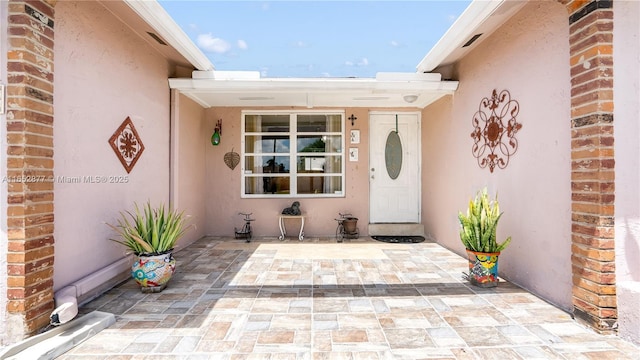 property entrance with a patio area