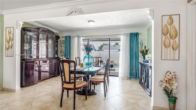 dining area with separate washer and dryer, light tile patterned flooring, and a textured ceiling