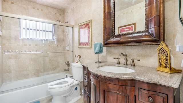 full bathroom featuring backsplash, vanity, enclosed tub / shower combo, and toilet