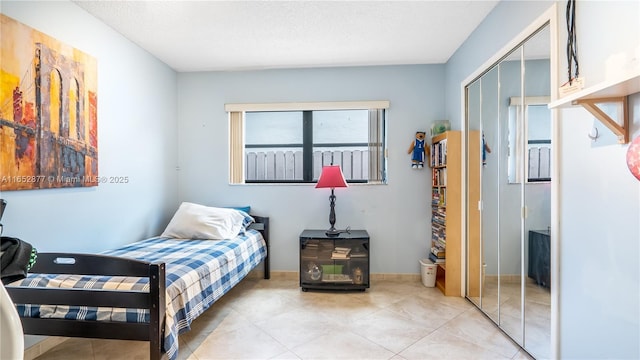 tiled bedroom featuring a closet