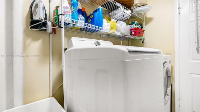 washroom with washing machine and clothes dryer