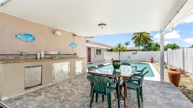 view of patio with a fenced in pool