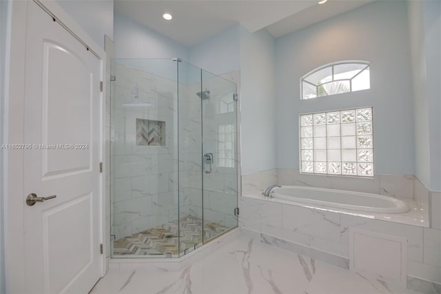 bathroom with separate shower and tub