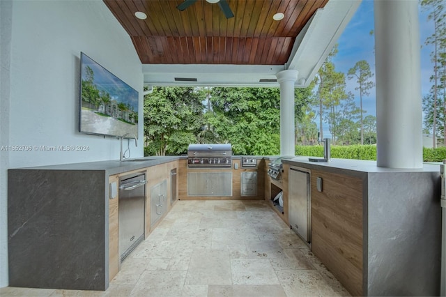 view of patio / terrace featuring a grill, ceiling fan, an outdoor kitchen, and sink