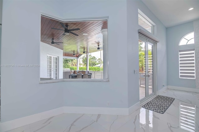 foyer entrance featuring wood ceiling, lofted ceiling, and ceiling fan