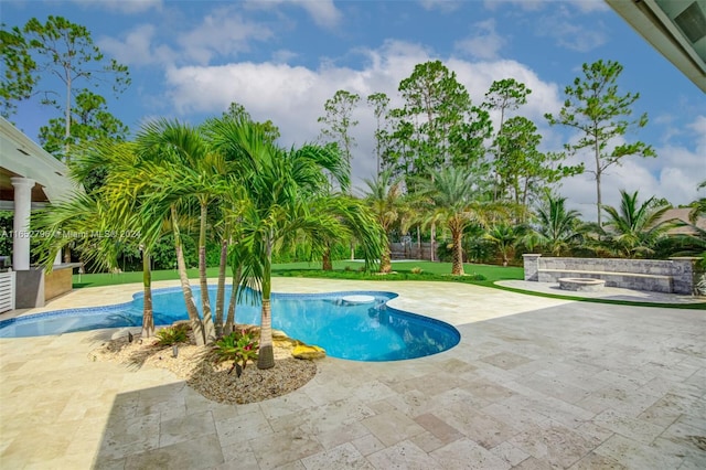 view of pool with a lawn and a patio area