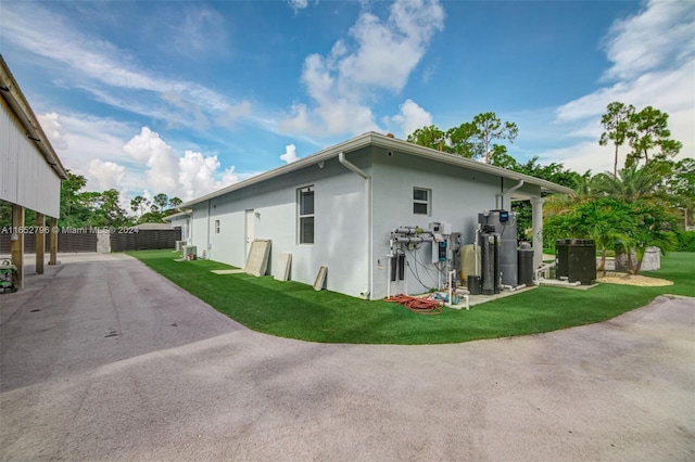 view of property exterior with a lawn