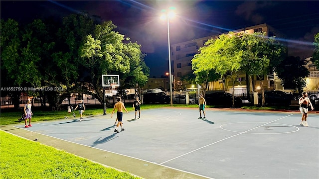 view of community featuring basketball court and a lawn