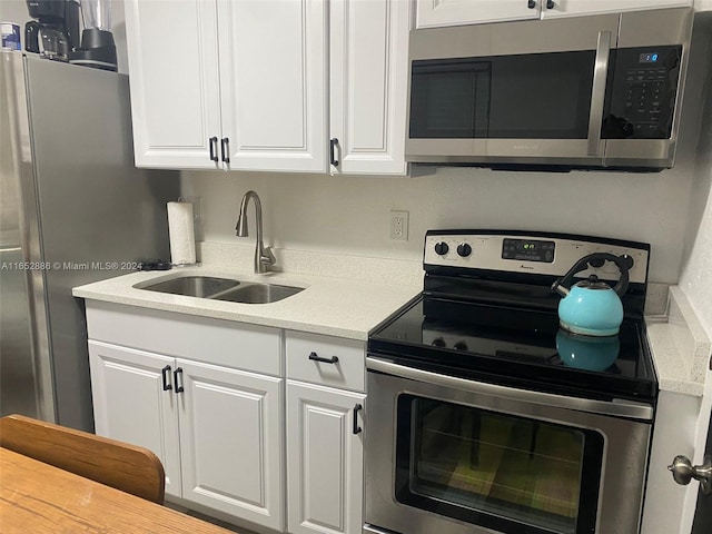 kitchen featuring white cabinetry, appliances with stainless steel finishes, and sink