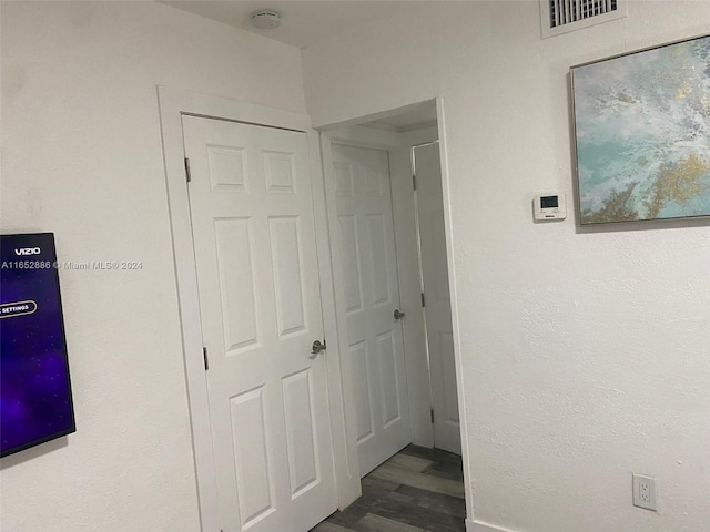 corridor with dark wood-type flooring