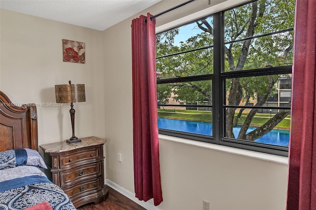 bedroom featuring dark hardwood / wood-style floors and a textured ceiling