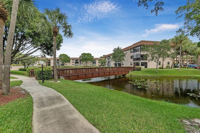 view of property's community featuring a water view and a yard