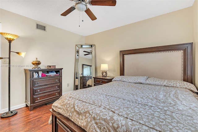 bedroom with wood-type flooring and ceiling fan