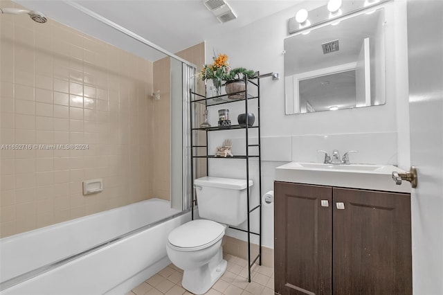 full bathroom featuring vanity, toilet, tile patterned floors, and tiled shower / bath