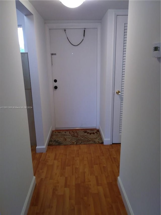 corridor with light wood-type flooring