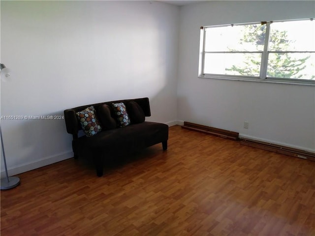 sitting room with wood-type flooring