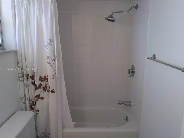 bathroom with toilet and shower / bathtub combination with curtain