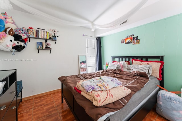 bedroom featuring dark tile patterned floors