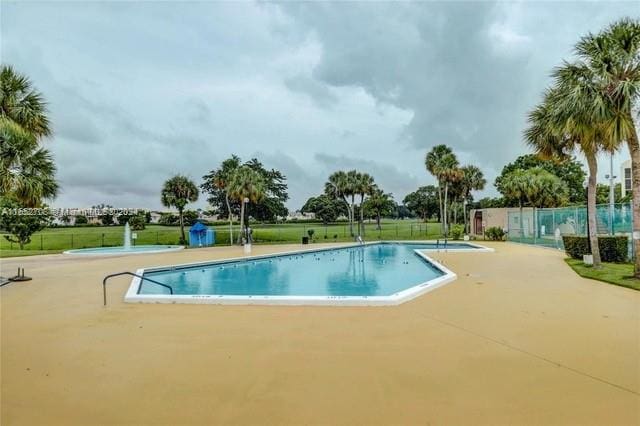 view of pool with a lawn and a patio area