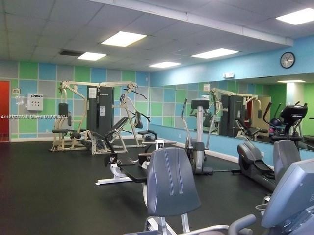 exercise room featuring a drop ceiling