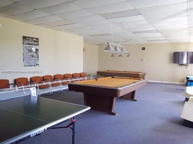 recreation room with a paneled ceiling, carpet, and pool table